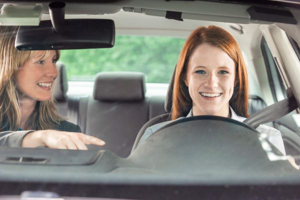 Student driver in the car with an instructor